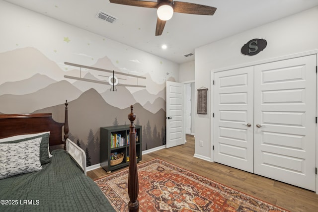 bedroom with hardwood / wood-style floors, a closet, and ceiling fan