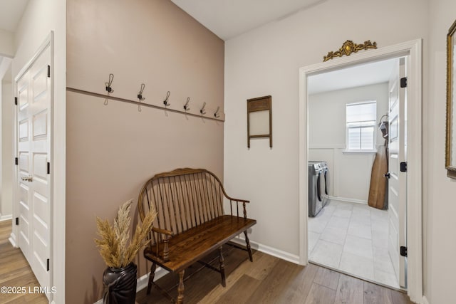 mudroom with hardwood / wood-style flooring and washer and clothes dryer