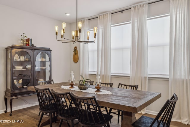 dining room with an inviting chandelier and dark hardwood / wood-style floors