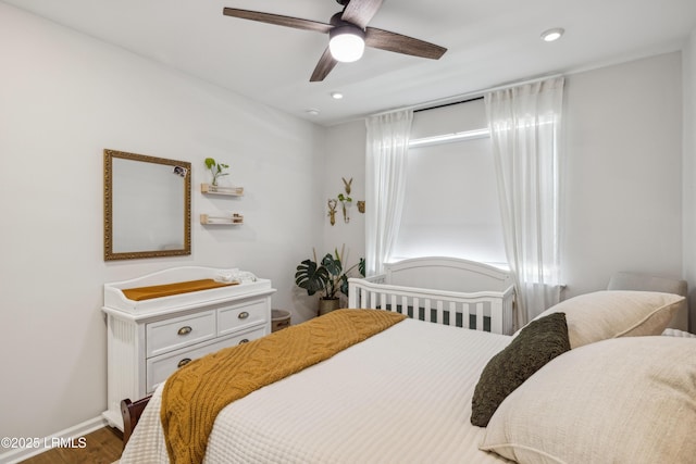 bedroom with hardwood / wood-style floors and ceiling fan