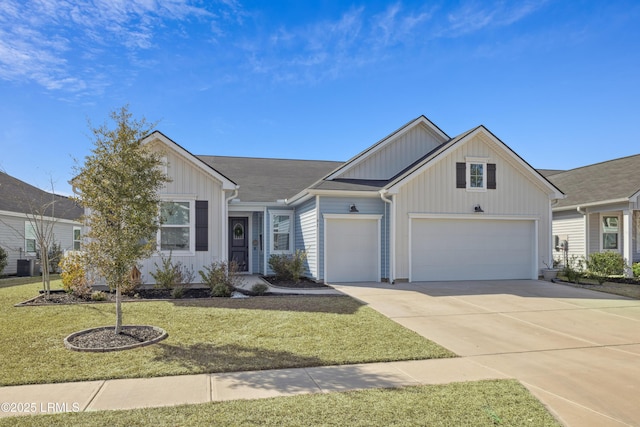 ranch-style home featuring a garage, a front yard, and central air condition unit