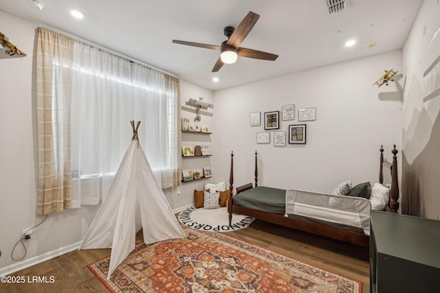 bedroom with dark wood-type flooring and ceiling fan