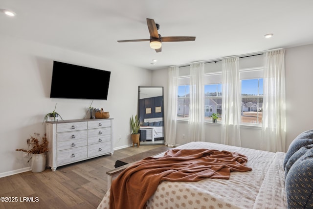 bedroom with ceiling fan and light hardwood / wood-style flooring