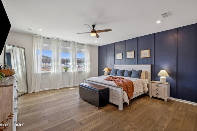 bedroom featuring ceiling fan and light hardwood / wood-style flooring