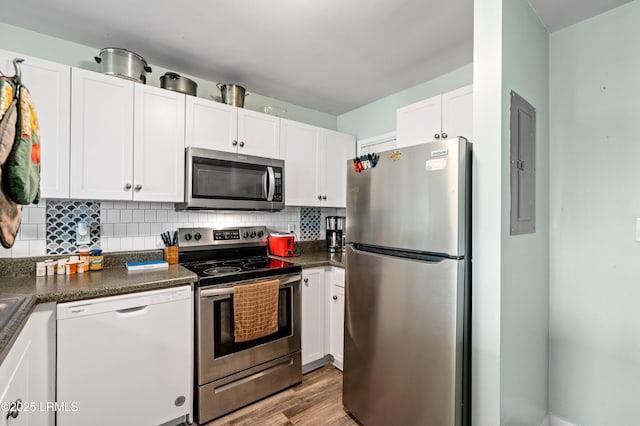 663 William Hilton Pkwy Unit 3404, Hilton Head Island, SC 29928 - kitchen with appliances with stainless steel finishes, dark countertops, white cabinetry, and tasteful backsplash