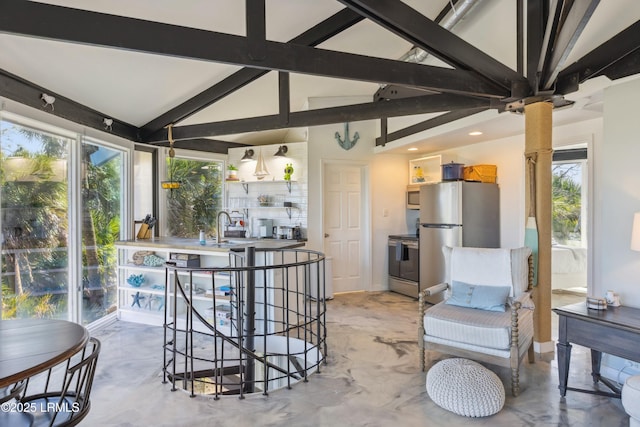 interior space featuring decorative backsplash, appliances with stainless steel finishes, vaulted ceiling with beams, open shelves, and a sink