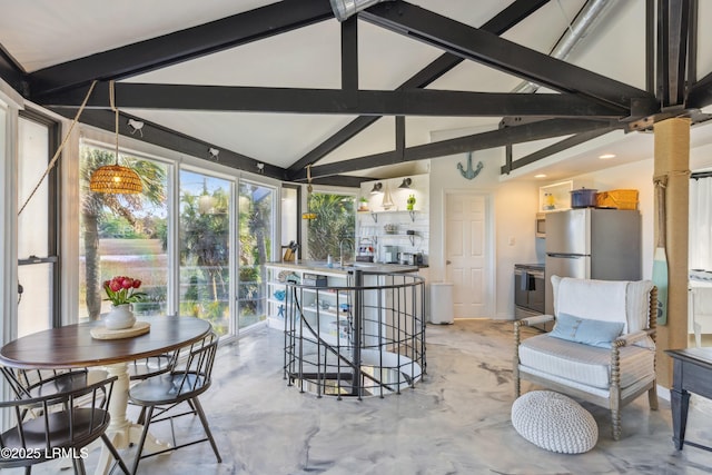 sunroom featuring lofted ceiling with beams