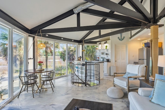 sunroom featuring vaulted ceiling with beams