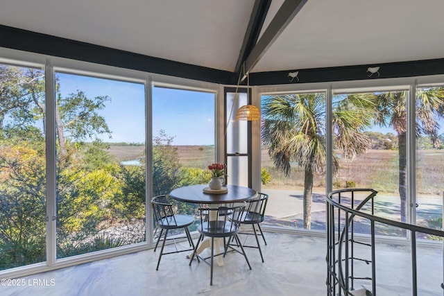 sunroom featuring lofted ceiling with beams