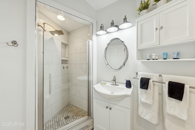 full bath with a shower stall and vanity