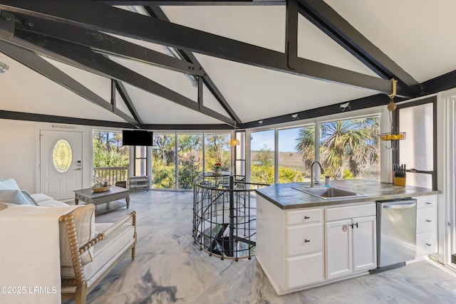 kitchen with dishwasher, dark countertops, open floor plan, white cabinetry, and a sink