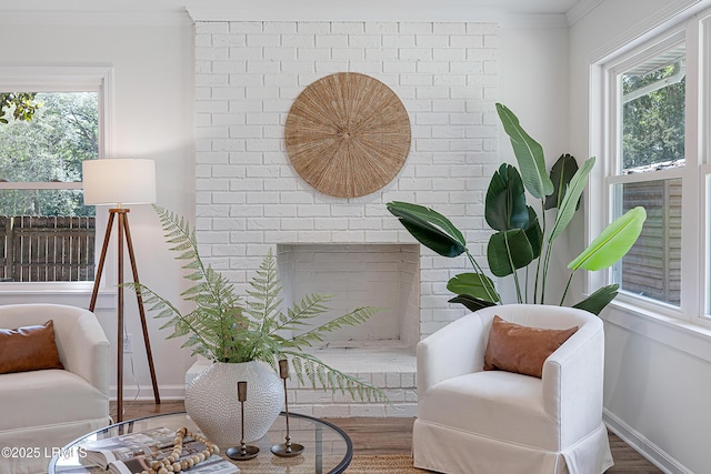 3017 Magnolia St, Beaufort, SC 29906 - sitting room featuring crown molding, healthy amount of natural light, baseboards, wood finished floors, and a brick fireplace