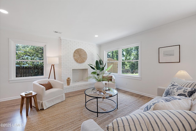 3017 Magnolia St, Beaufort, SC 29906 - living area featuring baseboards, wood finished floors, recessed lighting, a fireplace, and crown molding