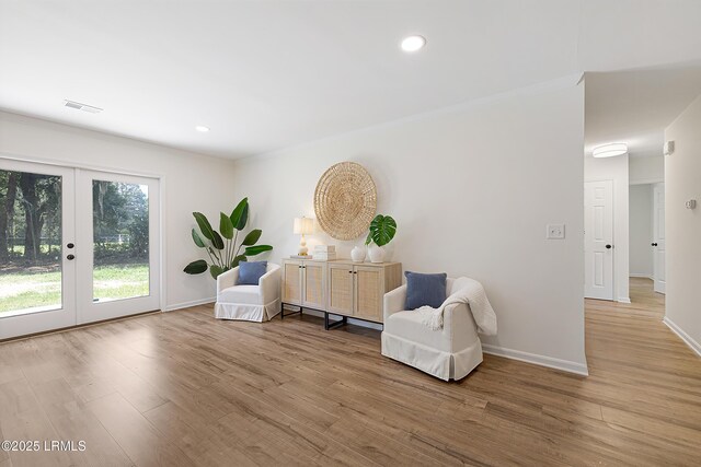 3017 Magnolia St, Beaufort, SC 29906 - living area with french doors, wood finished floors, baseboards, recessed lighting, and crown molding