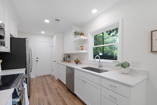 3017 Magnolia St, Beaufort, SC 29906 - kitchen with stainless steel appliances, a sink, white cabinetry, light wood-style flooring, and recessed lighting
