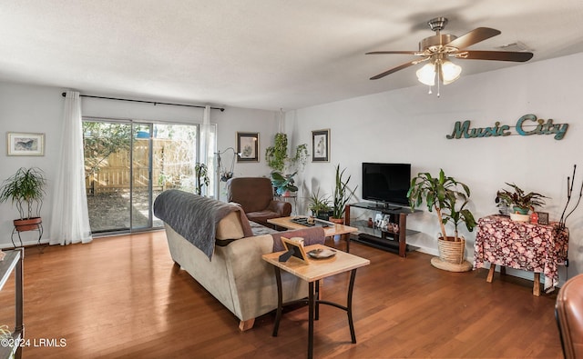 living room with hardwood / wood-style flooring and ceiling fan