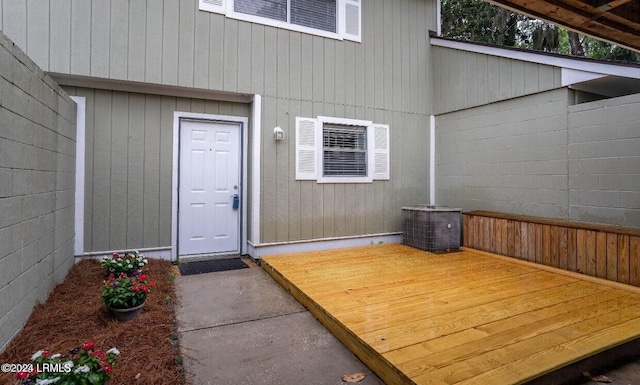 doorway to property with a deck and central air condition unit