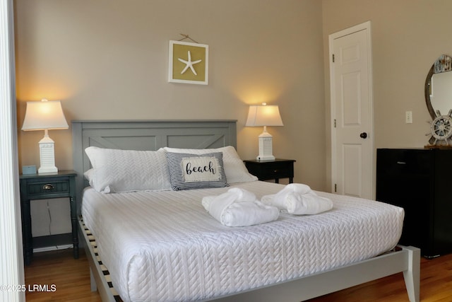 bedroom featuring wood finished floors