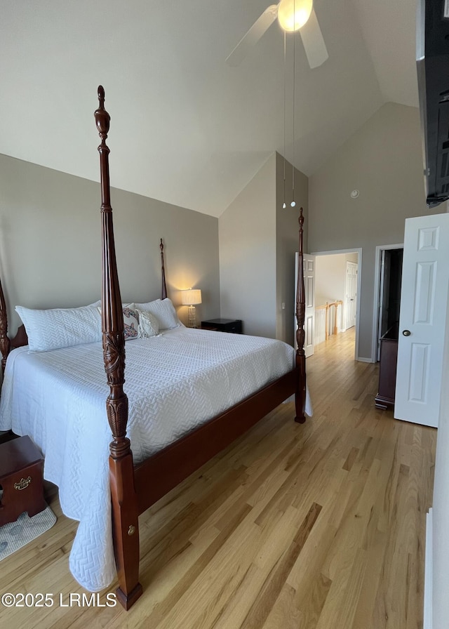 bedroom with high vaulted ceiling, a ceiling fan, and light wood finished floors