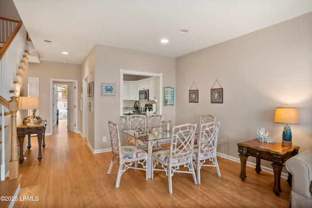 dining space featuring stairway, light wood finished floors, baseboards, visible vents, and recessed lighting