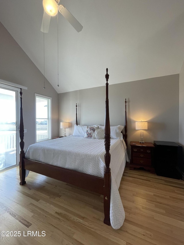 bedroom featuring vaulted ceiling, wood finished floors, access to exterior, and ceiling fan