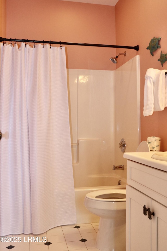 bathroom featuring shower / tub combo with curtain, toilet, vanity, and tile patterned floors