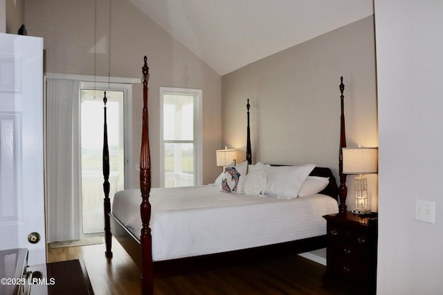 bedroom with wood finished floors and high vaulted ceiling