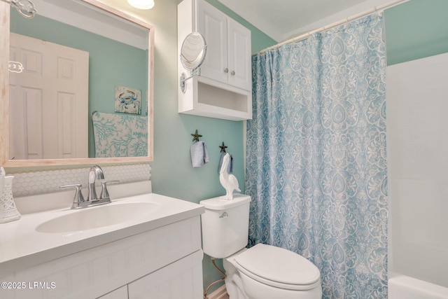 bathroom featuring toilet, shower / bath combo, and vanity