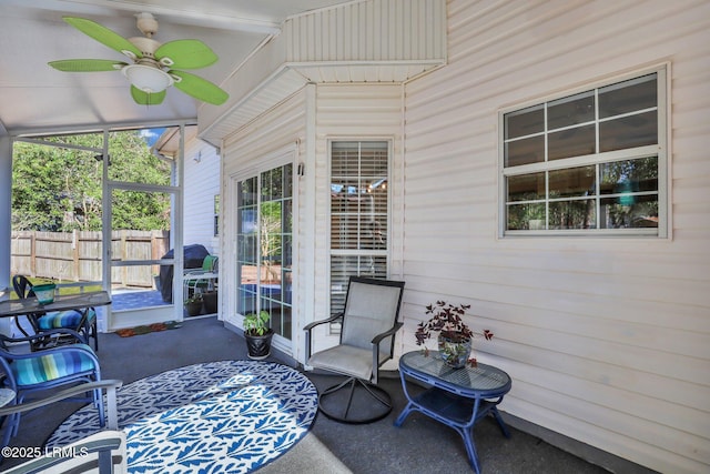 sunroom featuring a ceiling fan