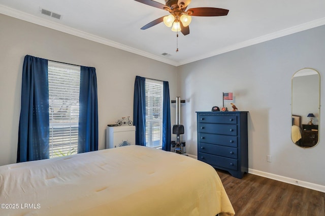 bedroom featuring ornamental molding, dark wood-type flooring, visible vents, and baseboards