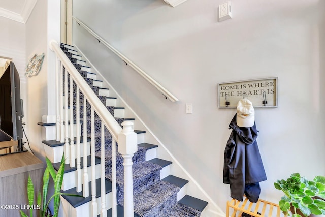 staircase featuring ornamental molding