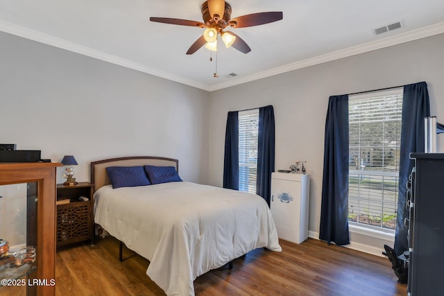 bedroom featuring baseboards, crown molding, visible vents, and dark wood-style flooring