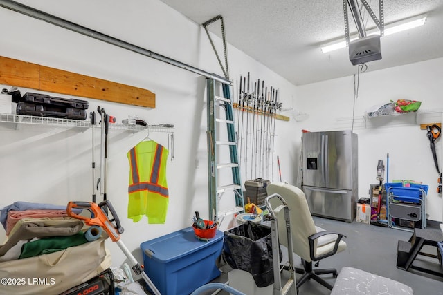 garage featuring stainless steel refrigerator with ice dispenser and a garage door opener