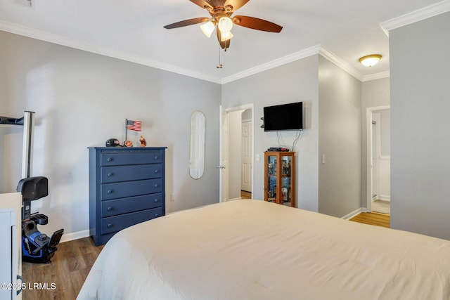 bedroom with baseboards, visible vents, ceiling fan, ornamental molding, and wood finished floors