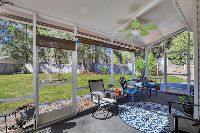 sunroom featuring vaulted ceiling and ceiling fan