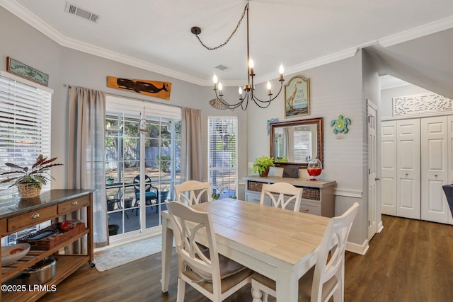 dining room with dark wood-style floors, visible vents, ornamental molding, and an inviting chandelier