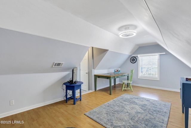 additional living space with visible vents, baseboards, and wood finished floors