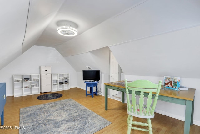 game room with baseboards, vaulted ceiling, and wood finished floors