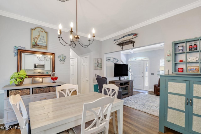 dining space with dark wood-style flooring and crown molding