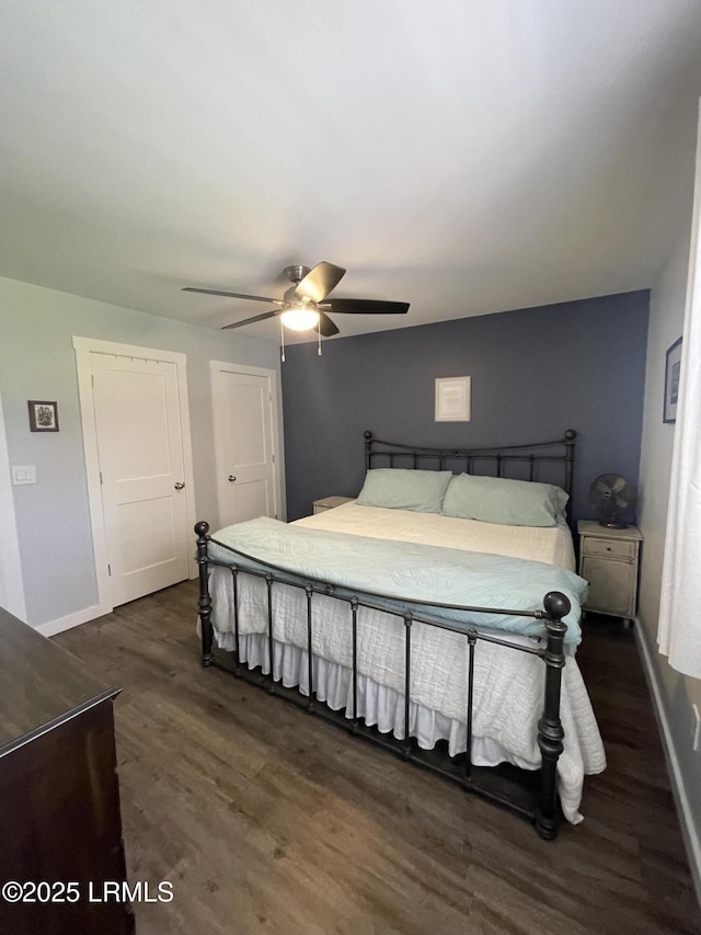 bedroom with dark hardwood / wood-style floors and ceiling fan