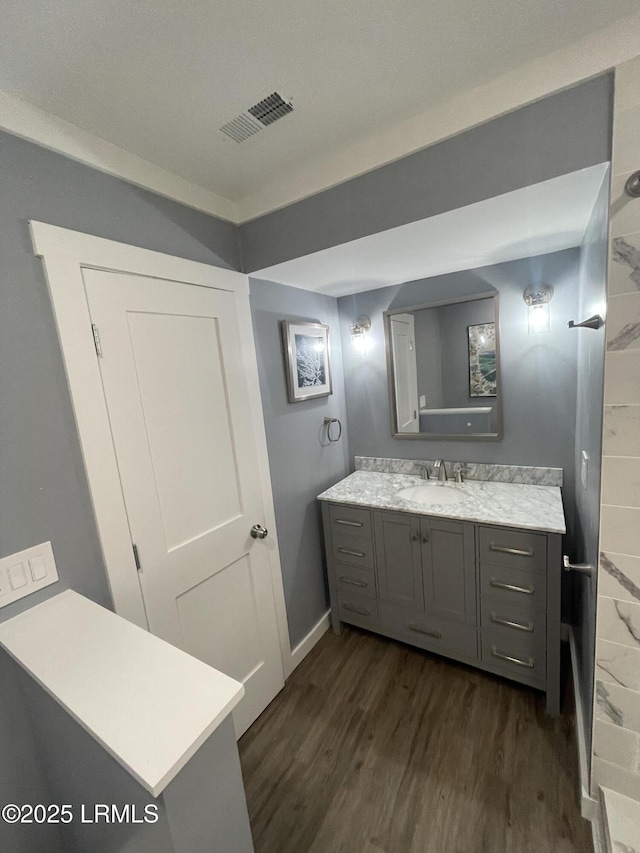 bathroom with vanity and hardwood / wood-style floors