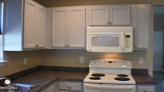 539 Candida Dr, Beaufort, SC 29906 - kitchen with a sink, dark countertops, and white appliances