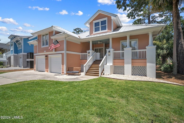 view of front of home with a porch, a garage, and a front lawn