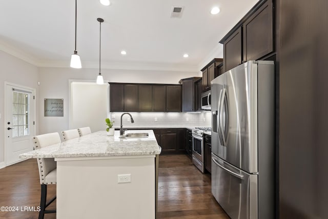 1034 Abbey Glen Way, Hardeeville, SC 29927 - kitchen with dark brown cabinets, a sink, stainless steel appliances, a kitchen bar, and ornamental molding