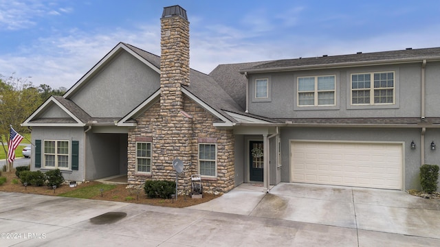 1034 Abbey Glen Way, Hardeeville, SC 29927 - view of front of house featuring stone siding, stucco siding, a chimney, an attached garage, and driveway