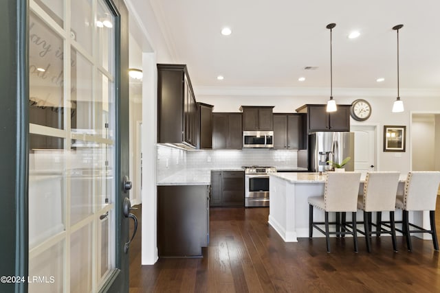 1034 Abbey Glen Way, Hardeeville, SC 29927 - kitchen featuring decorative backsplash, a kitchen breakfast bar, appliances with stainless steel finishes, a center island, and dark brown cabinets