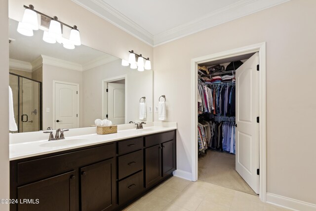 1034 Abbey Glen Way, Hardeeville, SC 29927 - full bathroom with crown molding, double vanity, a spacious closet, a shower stall, and a sink