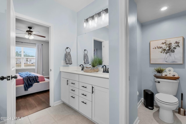 bathroom featuring tile patterned flooring, vanity, toilet, and ceiling fan