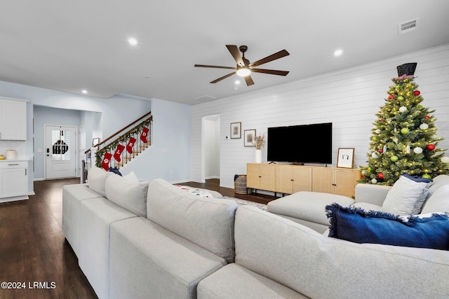 living room with ceiling fan and dark hardwood / wood-style flooring