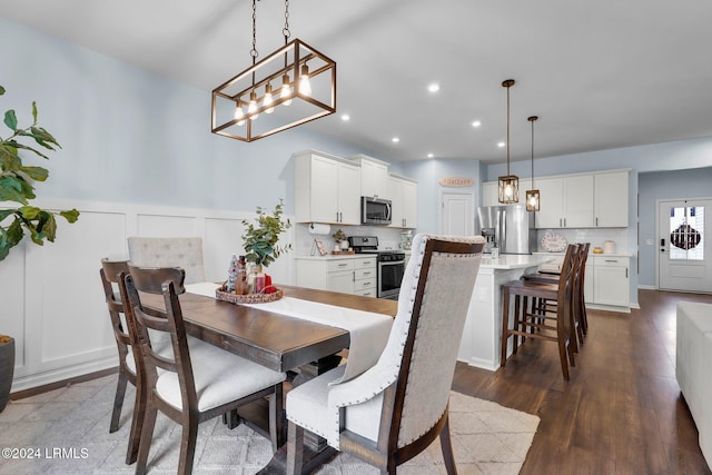 dining room with dark hardwood / wood-style flooring